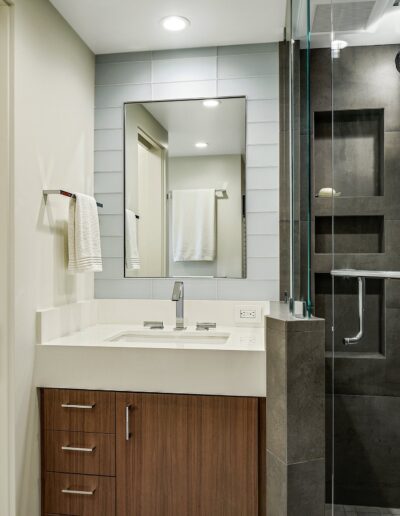 A bathroom with a toilet, sink and shower.