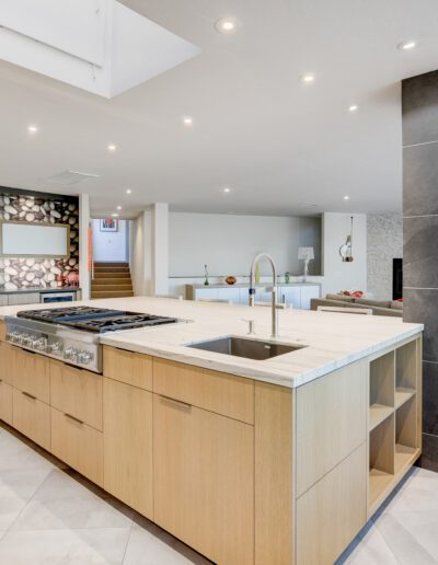 A modern kitchen with a large island and skylight.
